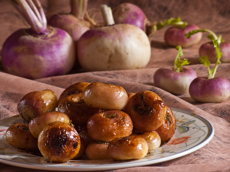 caramelized turnips on a plate with young turnips on a rose background